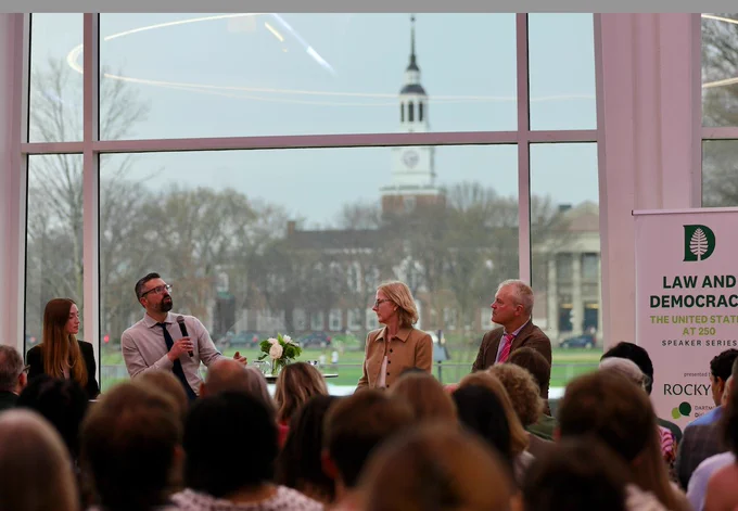 Ezra Klein and Heather Gerken sit along side the moderators in the Top of The Hop. The Baker/Berry Library tower can be seen across the Green.