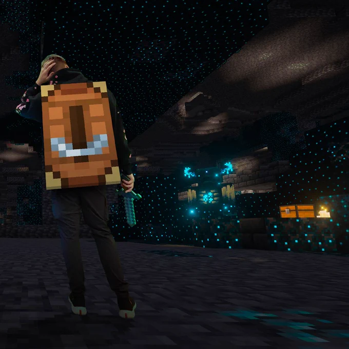 Person in Minecraft cape holding a sword