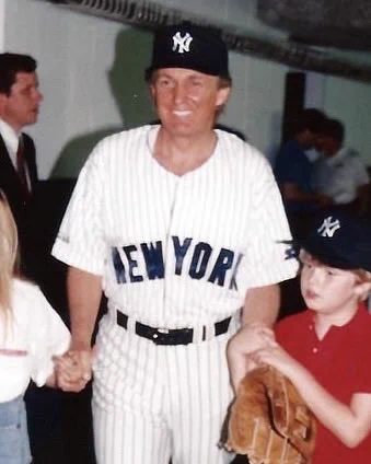Donald Trump wearing a Yankees jersey.