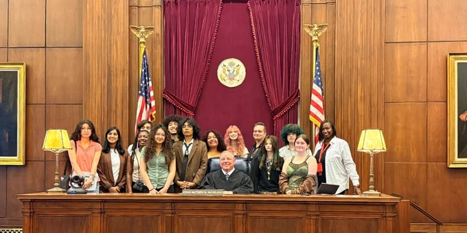 Students gather behind the judge's bench with Judge Matthew W. McFarland following an event at the Cincinnati federal courthouse. 