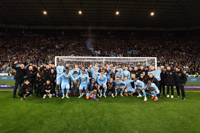 Coventry City players celebrate after winning the title.
