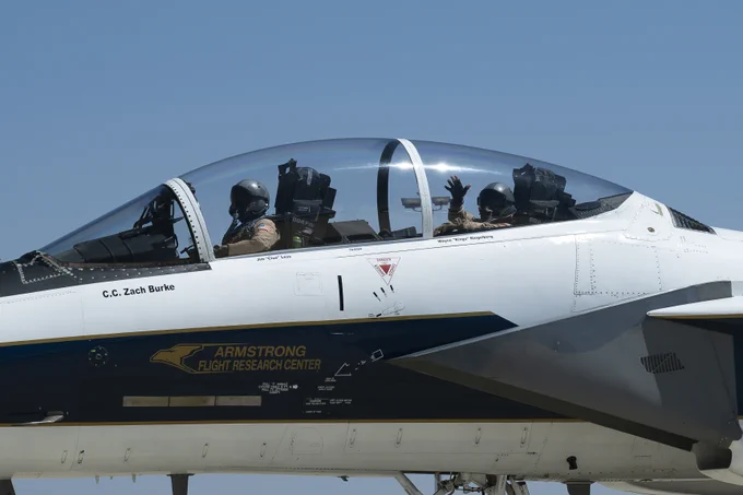 NASA aerial photographer Carla Thomas waves from the backseat of a NASA F-15 as chief pilot Wayne Ringelberg taxis following Thomas\u2019s 1,000th flight at NASA\u2019s Armstrong Flight Research Center in Edwards, California, on Monday, April 20, 2026. Credit: NASA/Carla Escamilla