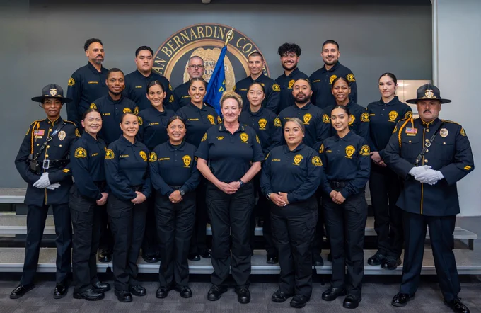 Probation officers pose for a graduation photo with the Chief Probation Officer and honor guard.
