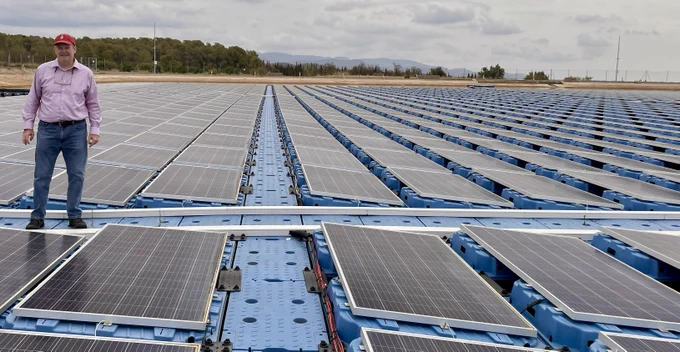 Michael Popp stands on a floating solar array in Spain.