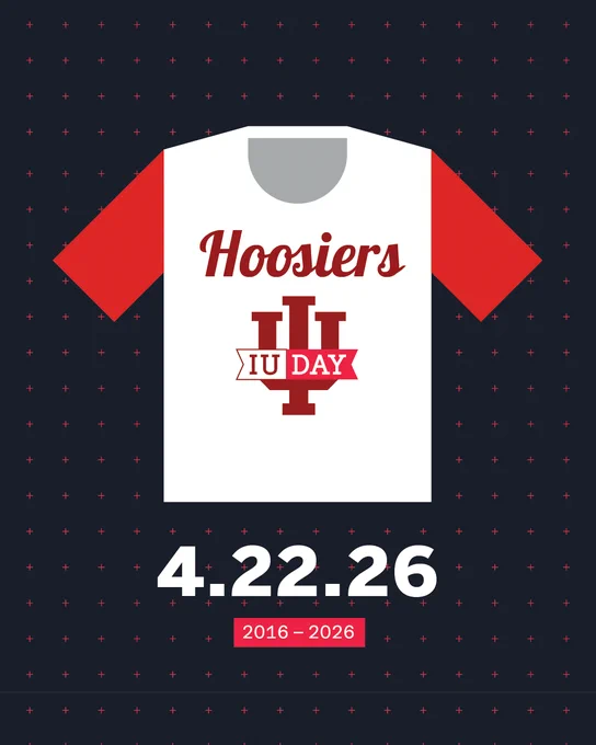 A graphic featuring a white shirt with red sleeves. The shirt has the word "Hoosiers" and a ribbon with "IU DAY" over the Indiana University logo. Below the shirt, the date "4.22.26" is displayed, with "2016 – 2026" beneath it. The background is dark with small cross patterns.