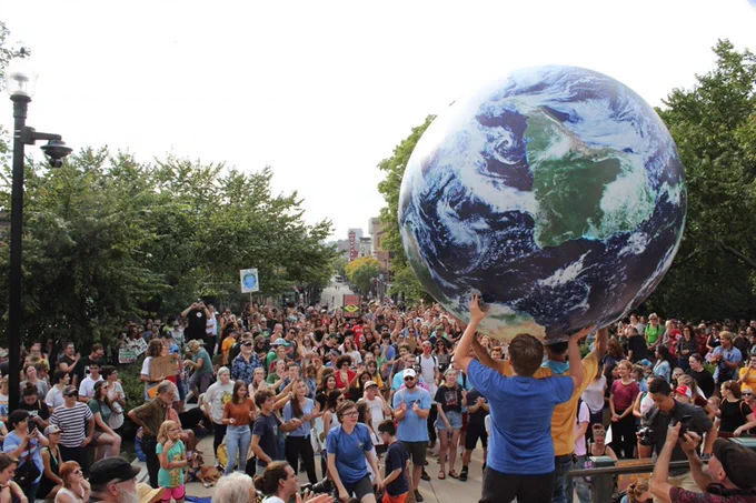 A crowd gathers to toss “inflated Earth ball” at an Earth Day Celebration event