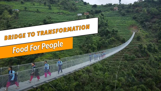 School children in Nepal fueled by nourishing meals from TPRF's Food for People program walk across a hanging bridge in the mountains.