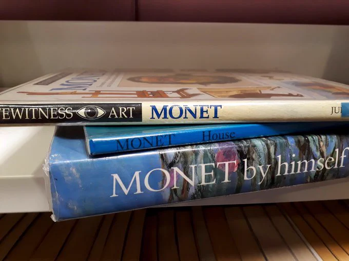 Three books about the artist Monet, lined up so the spines read Monet, Monet, Monet.