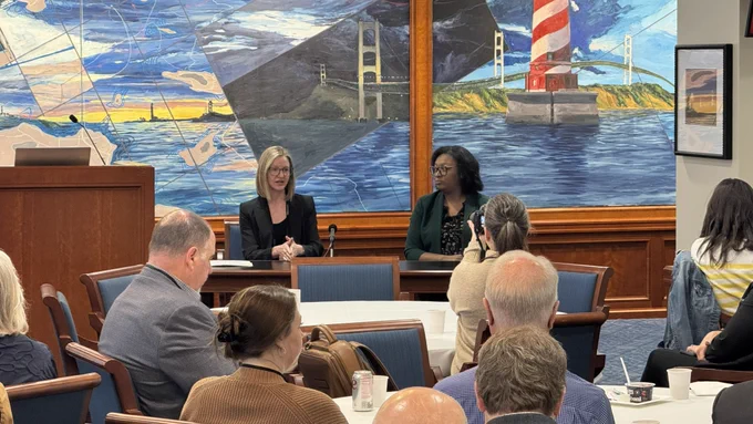 Director Flood and Senator Anthony speaking to an audience.