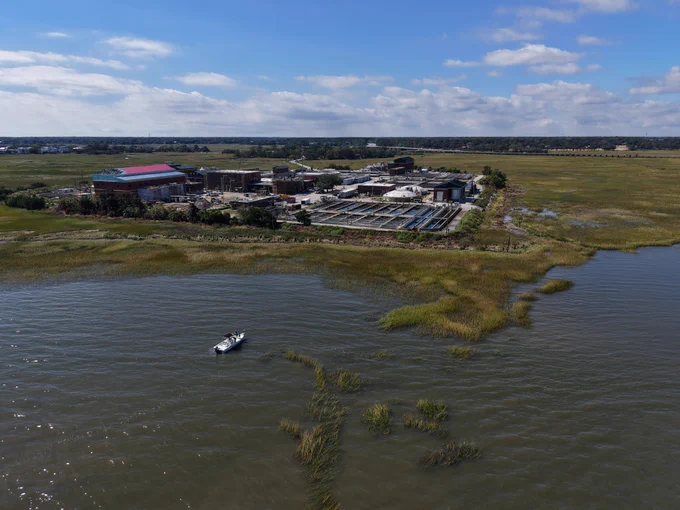 Aerial of a fishing boat in front of our wastewater treatment plant