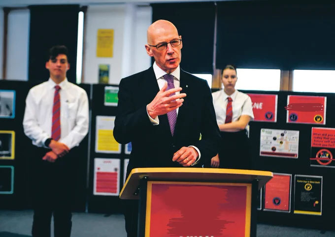 John Swinney and me standing behind him on exam results day 2020