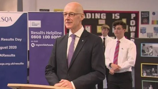 John Swinney and me standing behind him on exam results day 2020