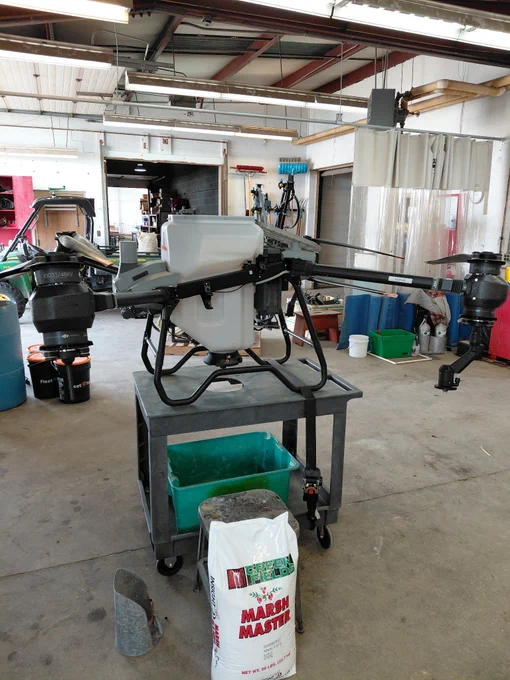 A large drone sites on a cart in a shop to be prepared for various research trials.