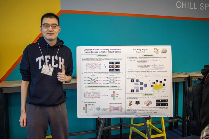 Georgia Tech School of CSE Ph.D. student Yule Wang takes a picture with his group's poster on MIS-Vis, an AI tool that helps decode how the brain processes what is seen through the visual cortex. The group will present MIS-Vis at the International Conference on Learning Representations (ICLR 2026), occurring April 23-27 in Rio de Janeiro.