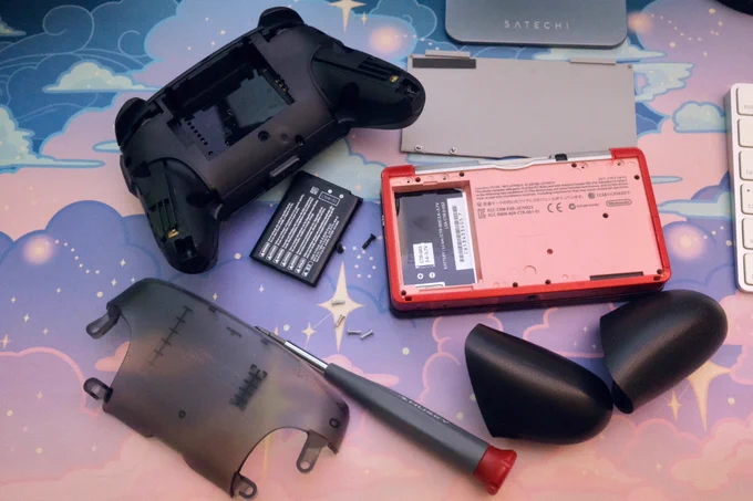 A Switch Pro Controller disassembled to remove the battery, and a red 3DS with its backplate and battery slot empty.