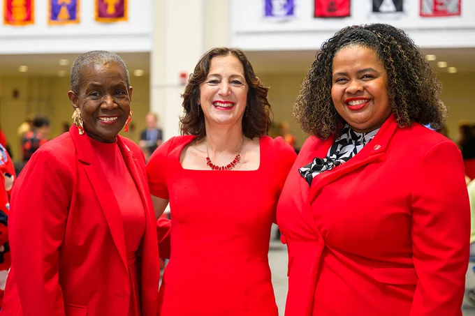 President Goldsmith poses with two attendees during an inauguration week reception.