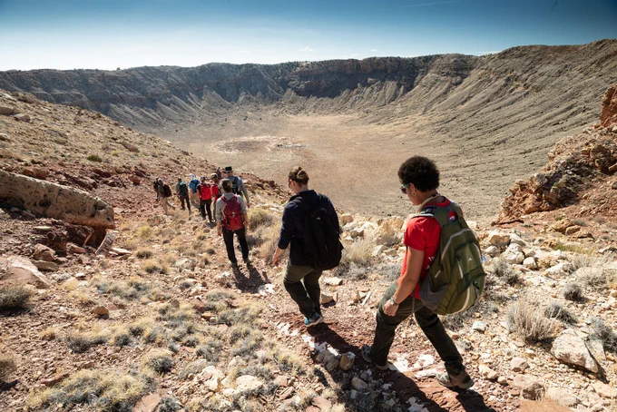  Artemis astronauts hiking below the rim of Meteor Crater during astronaut training