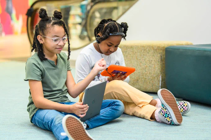 Two elementary students read digital books at the Richland County Public Library. Photo credit: RCPL