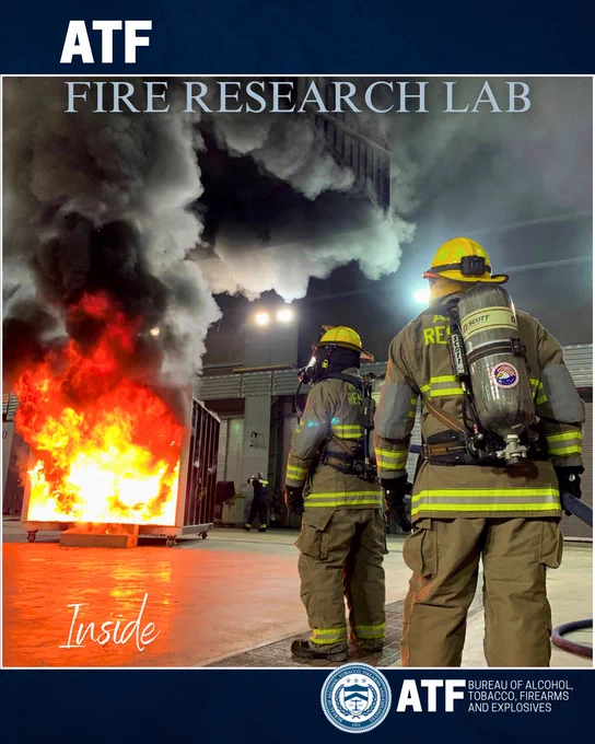 Two ATF fire suppression engineers observe a large controlled fire at the ATF Fire Research Lab during a test.