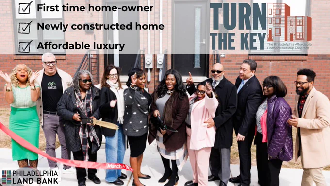 photo of group of people cutting the ribbon at a new turn the key home