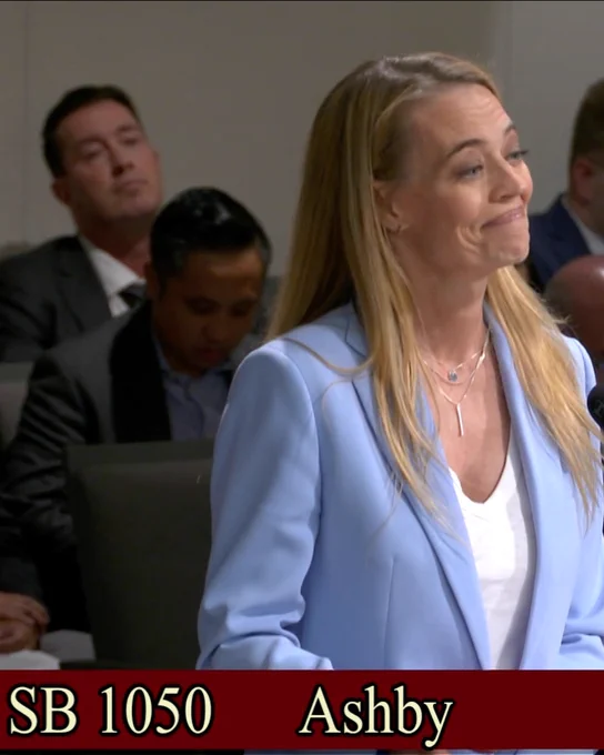 Jeri Ryan smiling with her mouth closed. A banner along the bottom reads: SB 1050. Ashby. 