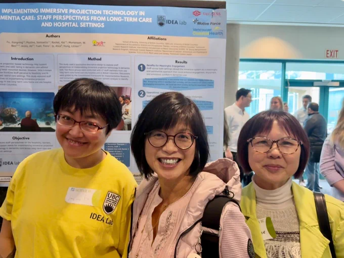 Postdoctoral fellow Dr. Jiangning Fu, Dr. Lillian Hung, and Zarina Chan posing for a picture in front of their poster, “Implementing immersive projection technology in dementia care: Staff perspectives from long-term care and hospital settings,” at the INCREASE BC 2026 Conference in Vancouver.