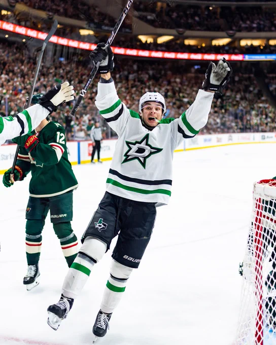 Wyatt Johnston celebrating on ice in a Stars uniform.