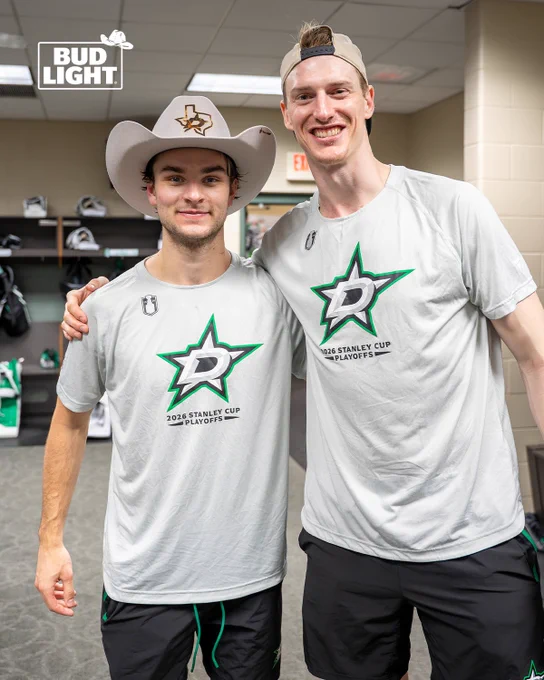 Wyatt Johnston and Tyler Myers pose with the team victory cowboy hat