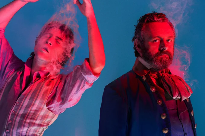 A photo showing two figures in smoking, antiquated garb 