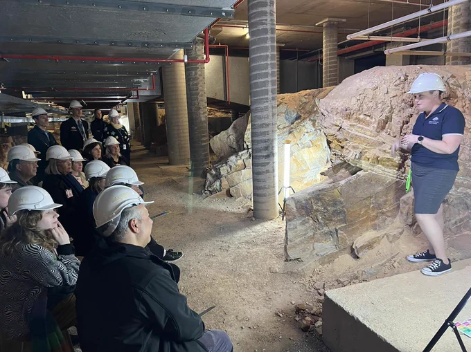 Dr Verity Normington guiding an Unconformity tour deep below the foundations of Parliament House in Australia.