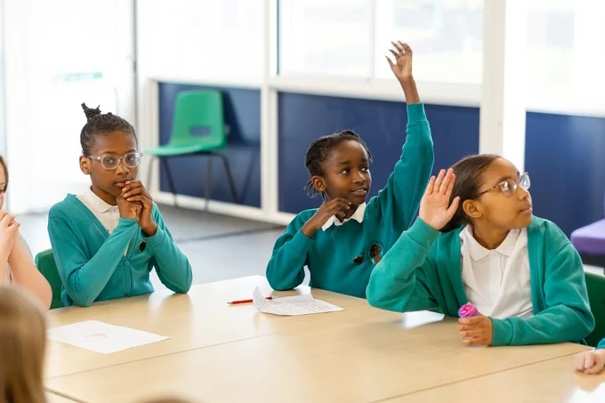 Garden City Academy pupils raising their hands
