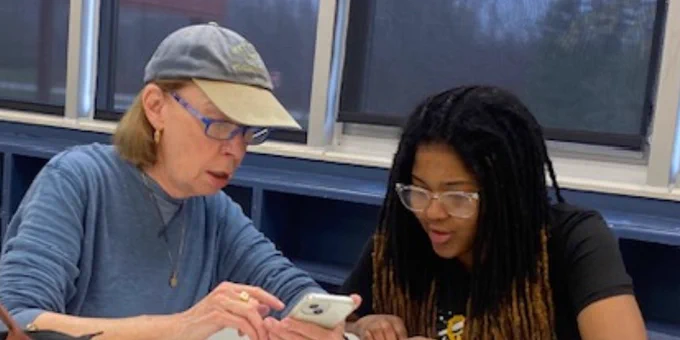 OCHS students working with senior citizens during the phone tips workshop.