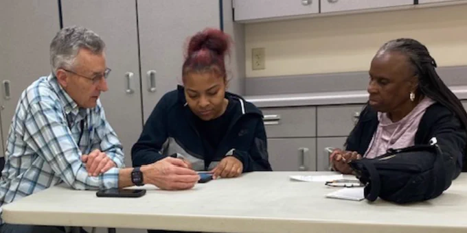 OCHS students working with senior citizens during the phone tips workshop.