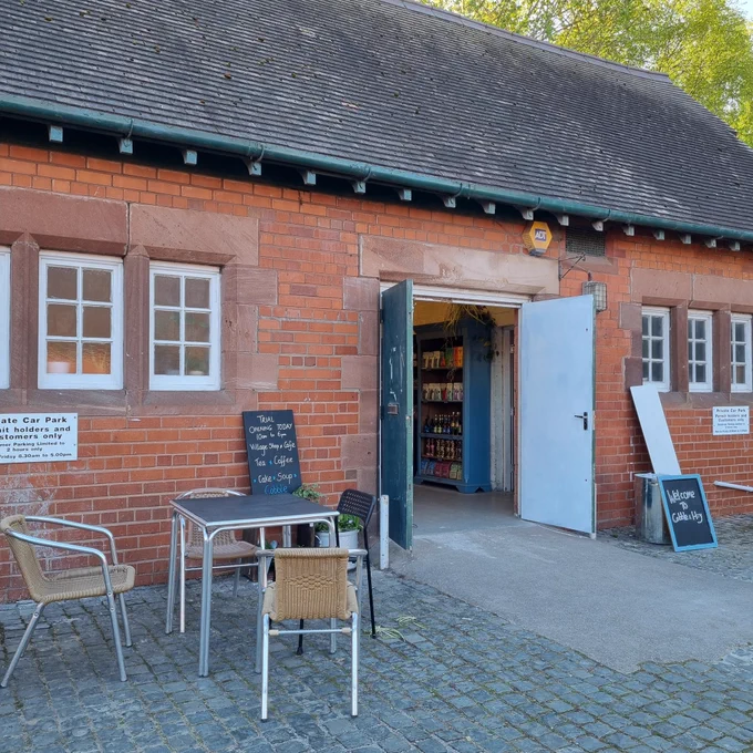 Outside old red-brick stable block in cobbled courtyard, now re-vamped as cafe. Outdoor tables