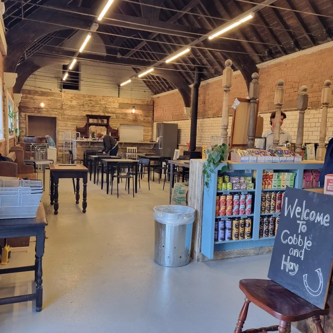 Area with tables and chairs ready to serve tea, coffee, cakes and lunch.