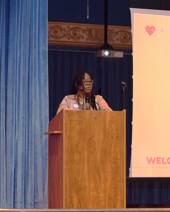 Chair of the African American Health Coalition Dr. Mary Bisbee-Burrows on stage. 