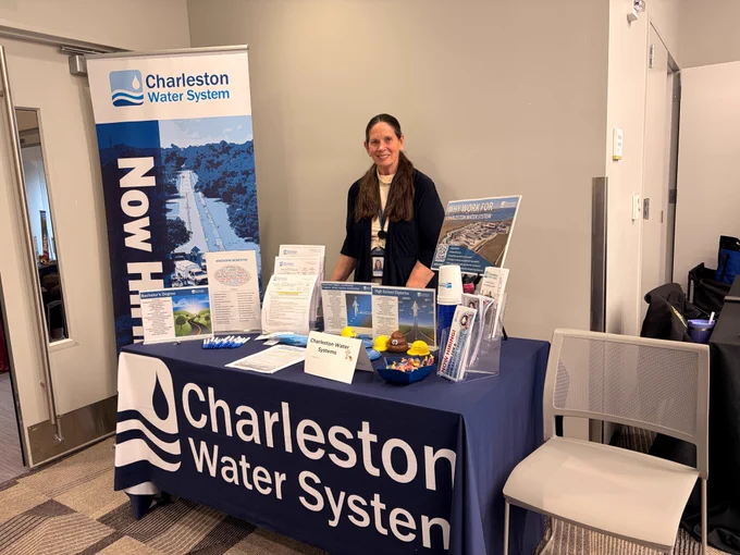 Woman standing at an information booth