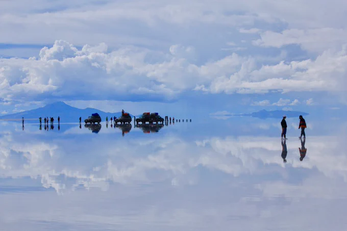 Silouettes of people and cars at the Uyuni Salt Flat in Bolivia.