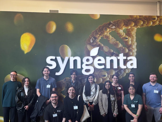 The 2026 Career Exploration Initiative attendees and Dr. Rachel Egger in front of a Syngenta sign. 