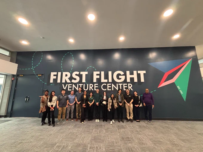 The 2026 Career Exploration Initiative attendees with Program Director Dr. Balaji Vasudevan (right) and Program Manager Ashley Davis (left) in front of a First Flight Venture Center sign. 