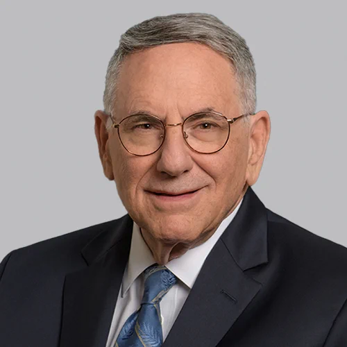 Head shot of Corporate Attorney Zane Averbach on a light gray background.