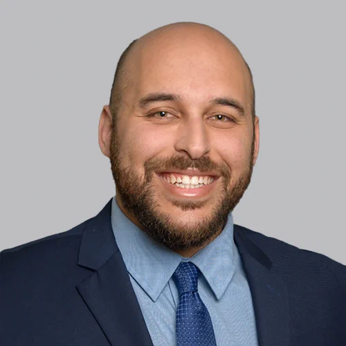 Head shot of Business Attorney Joshua S. Stein on a light gray background.