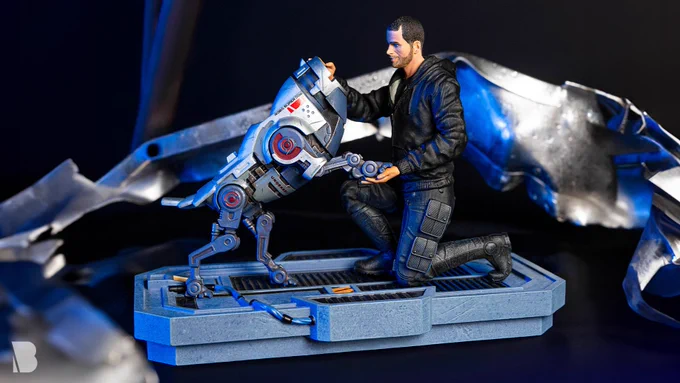 The 5.9 in (15 cm) tall Mass Effect Shepard and KEI-9 Statue, a resin statue portraying male Commander Shepard petting his robot dog. Limited edition of only 2,000 worldwide.