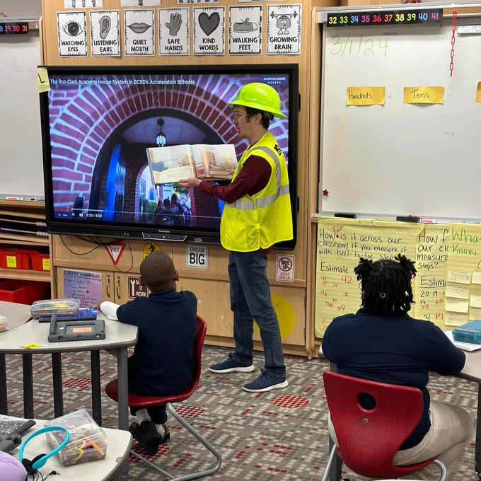 Employee reading to a classroom