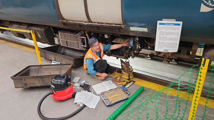Tom with electrical parts and tools scattered around 507001.