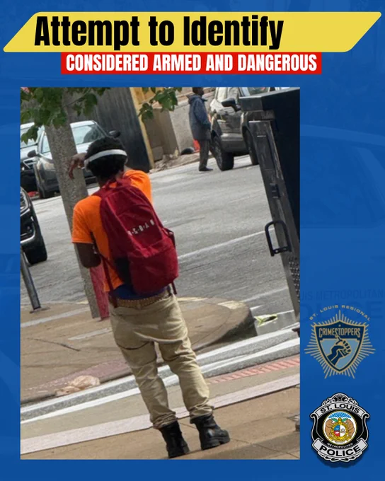 Public safety flyer with the headline "Attempt to Identify" and a red banner reading "Considered Armed and Dangerous."  The central image shows the back of a man walking on a sidewalk. He's described as a black male, medium build, wearing an orange shirt, tan pants, brown studded belt with a large brown buckle, black boots, a red bookbag and white/silver headphones. He is holding an object in both hands. CrimeStoppers and St. Louis Police logos appear on the right side.
