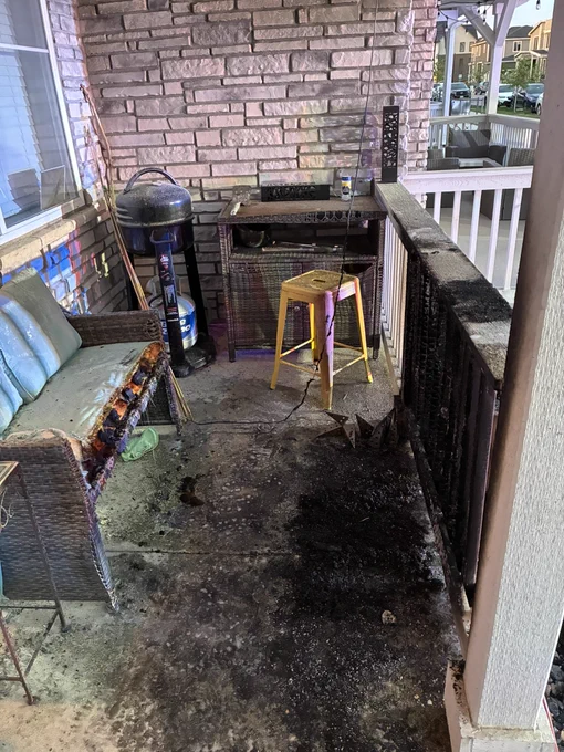 Daytime image of the front porch of a home with fire damage