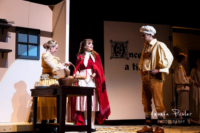 The Baker, the Baker's Wife, and Little Red Riding Hood sing in a bakery in "Into the Woods."