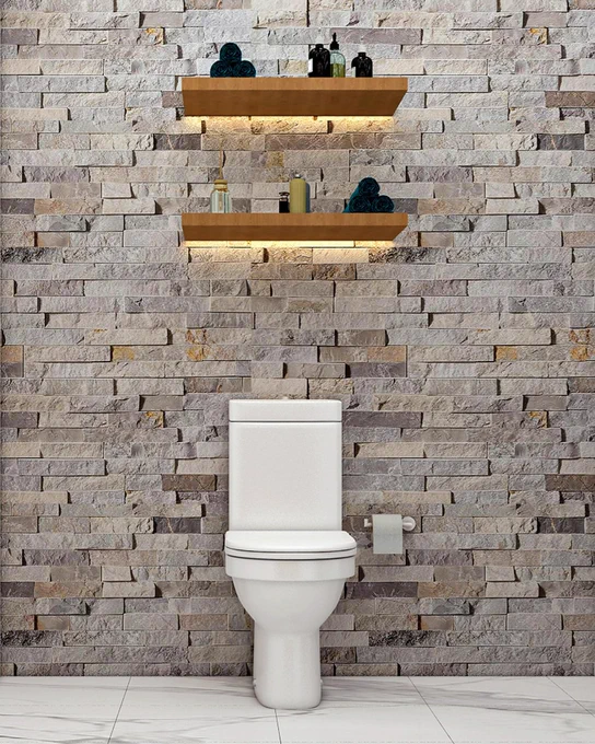 A modern bathroom interior featuring a white toilet against a textured stone wall. Above the toilet, two wooden shelves hold decorative items and toiletries, with soft lighting highlighting the arrangement. The floor is made of white marble tiles.