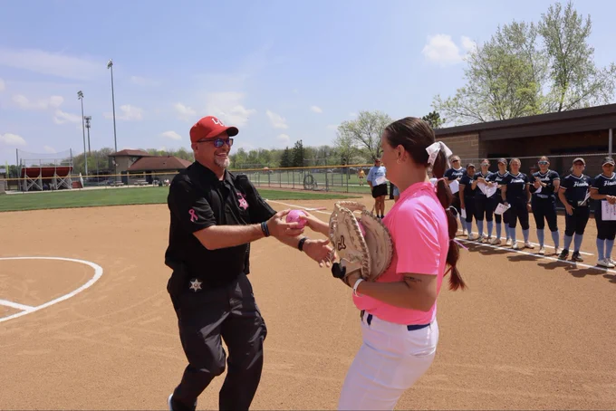 Catcher returns ball to Officer Roy who threw out the ceremonial first pitch.